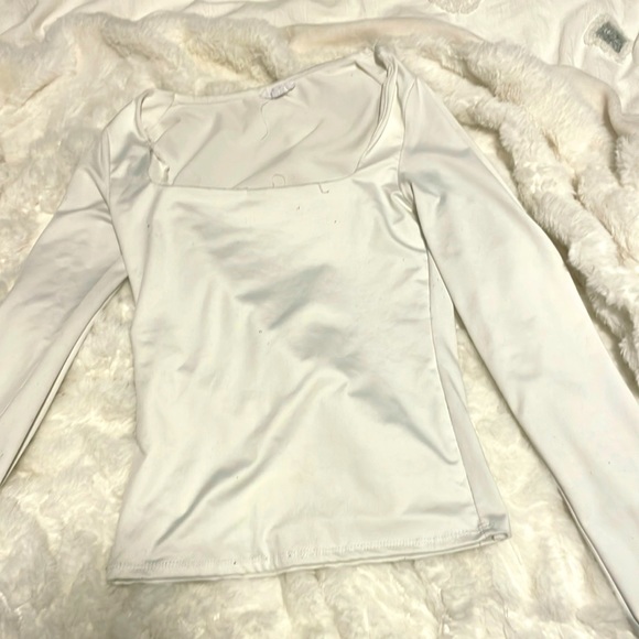 This is a great top the material is silky is a nice white almost never worn! - Picture 1 of 4